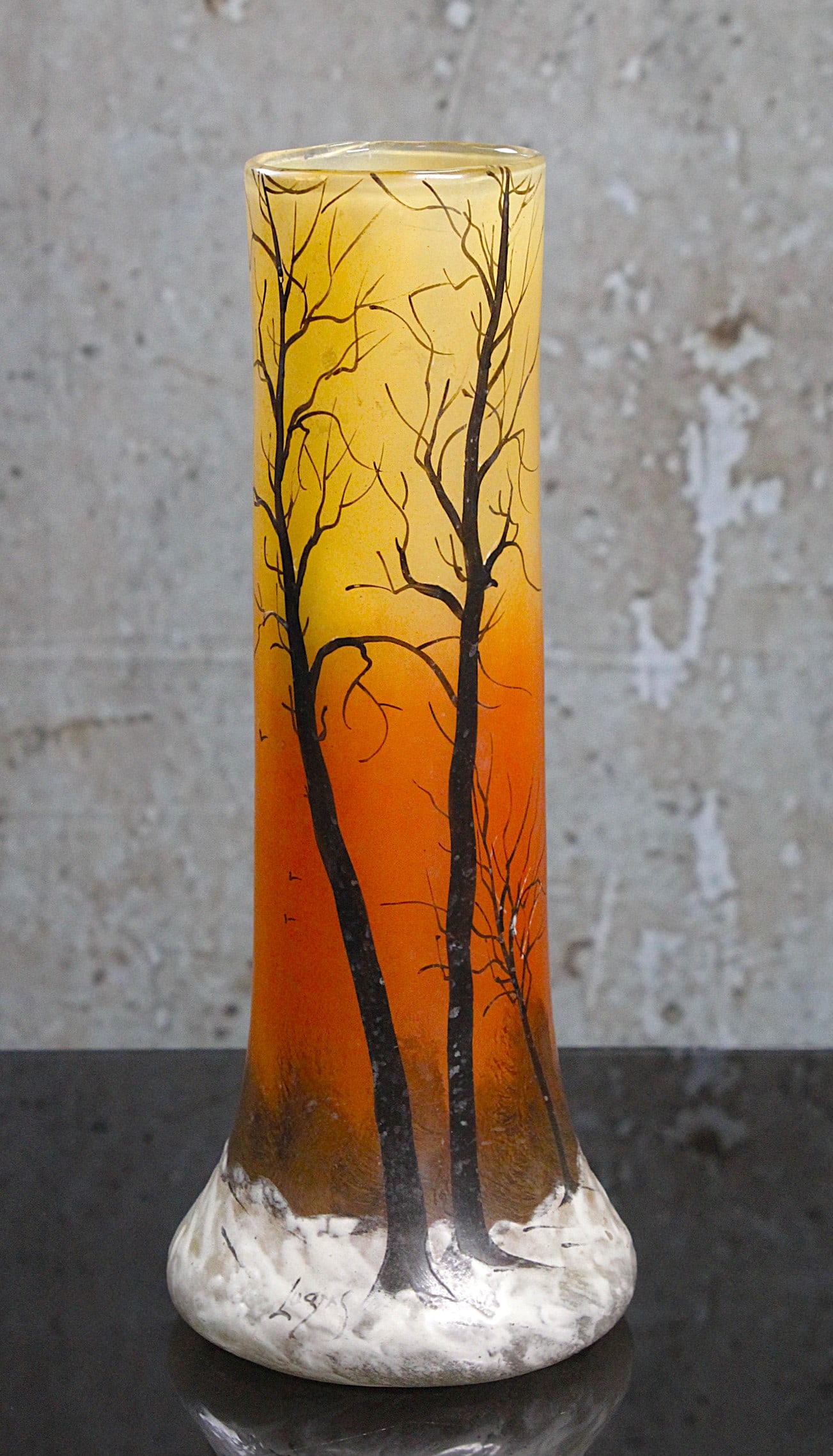 A Legras Winter Scene French Art Glass Vase: Enameled with thick frosty white on an amber ground w/barren trees in charcoal, signed in enamel "Legras" Exc cond. 12"H.