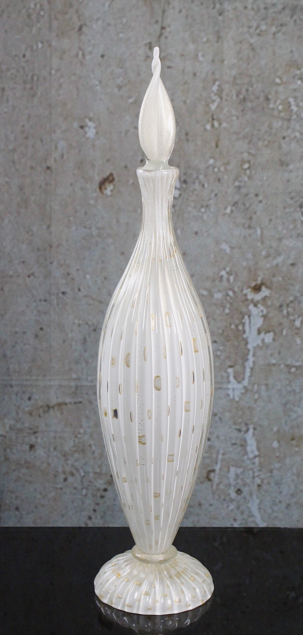 Another Alfredo Barbini Murano Art Glass Bottle: Circa 1950's in elongated opal glass with vertical ribs internally decorated with controlled bubble windows outlined in gilt surmounted with a matching stopper, Exc. cond. 20.25"H.