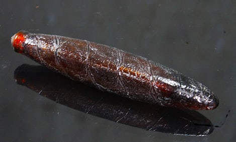 A Victorian Figural Cigar Whiskey Nipper.