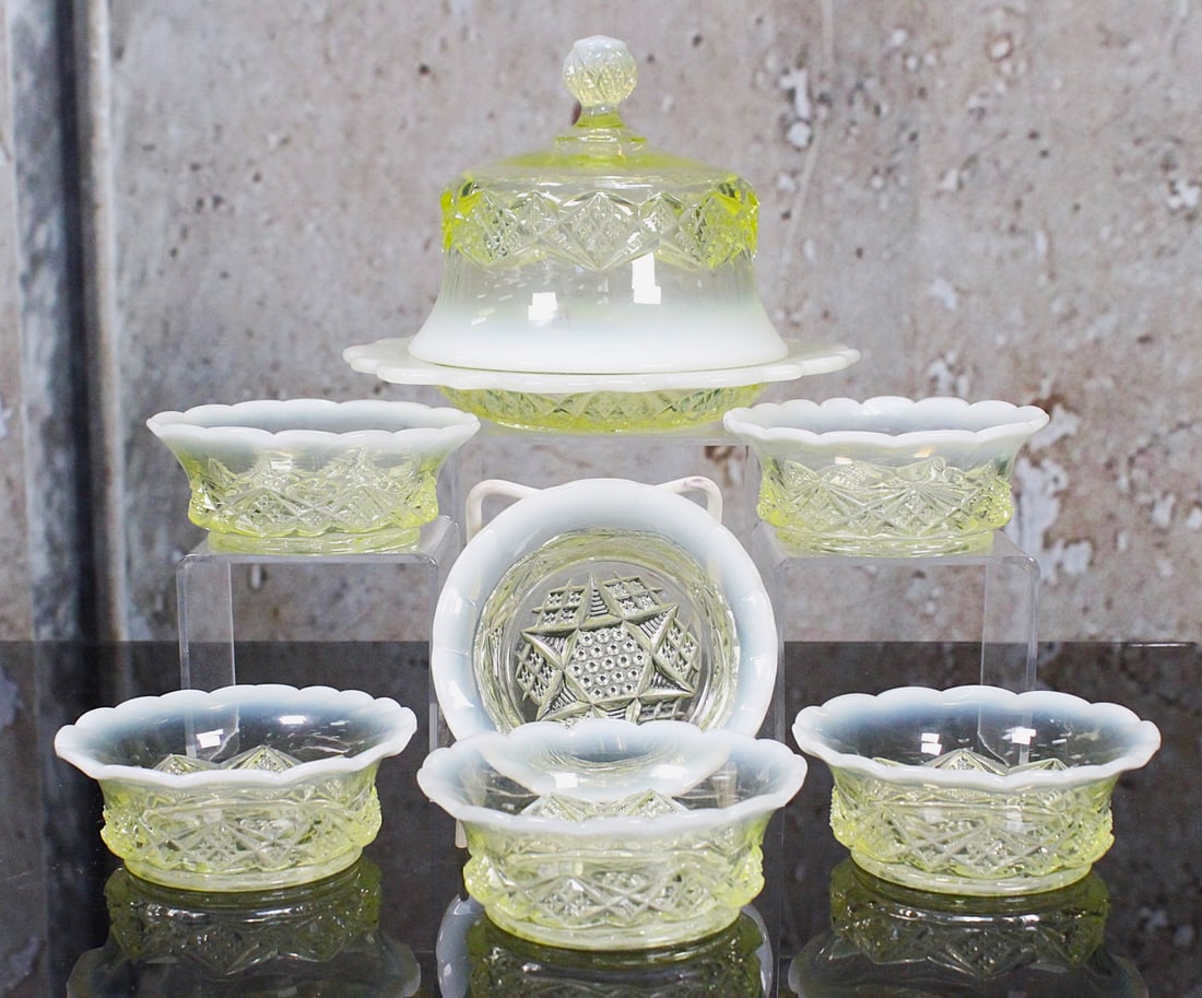 A 7Pc Northwood Victorian Opalescent Table Setting: Vaseline/uranium glass in diamond spear pattern comprising a covered butter and 6 individual sauces VG+ cond. noting a chip on butter base flange not seen with cover in place, Largest 7"Dia.