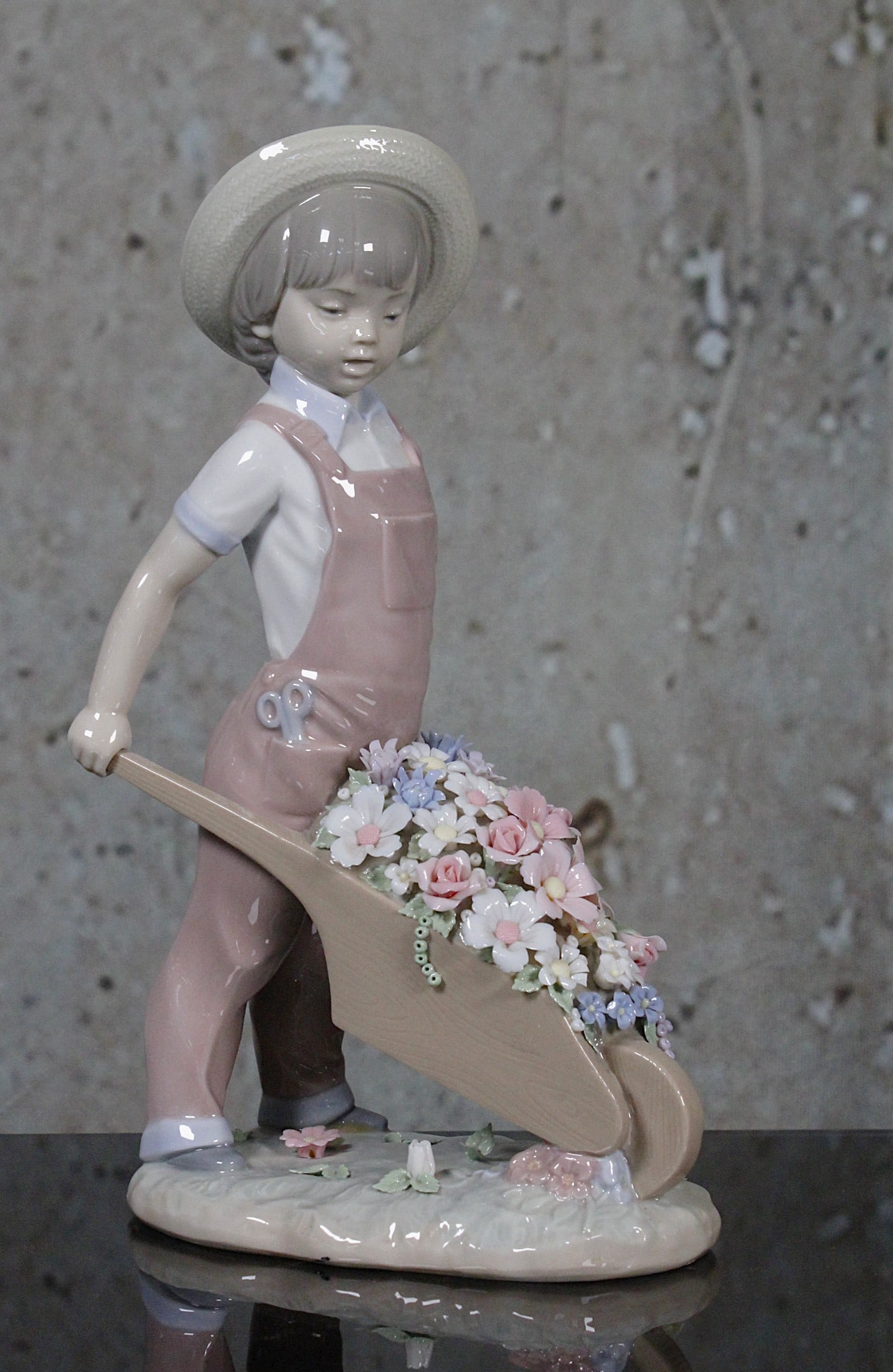 A Lladro Porcelain Figure "Little Gardener": #1283, issued 1973, artist signed and dated 7/14/93, Exc. cond, includes orig. box not illustrated, 9.75"H.