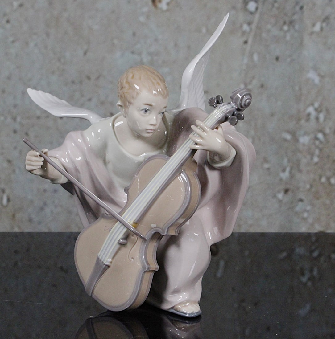 A Lladro Porcelain Figure "Heavenly Cellist": #5492, retired 1993, Artist signed and dated 7/13/92, Exc. cond, includes original box not illustrated. 8.25"H.