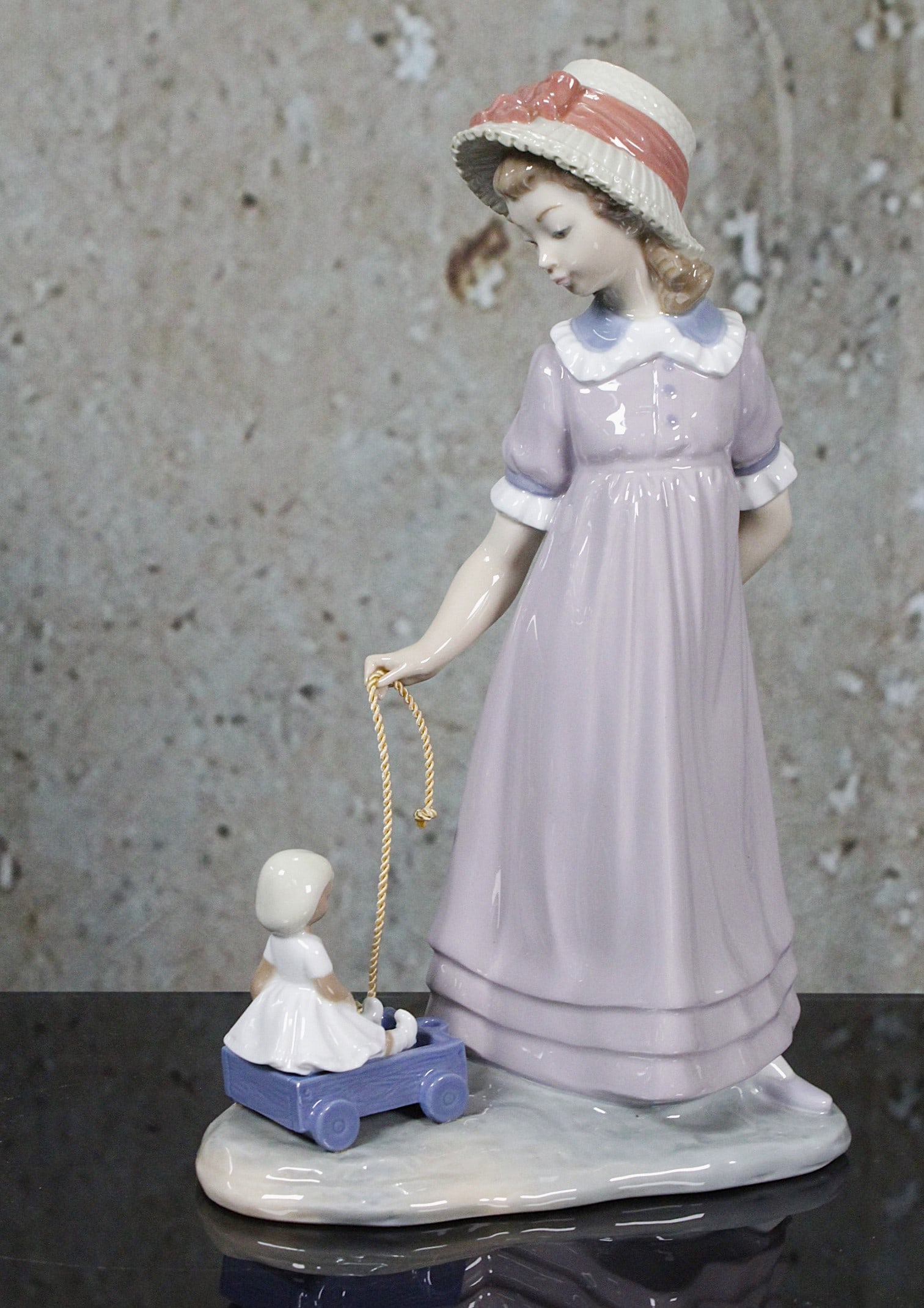 A Lladro Porcelain Figure "Girl With Toy Wagon": #5044 produced 1980 and retired in 1998, Artist signed and dated 2/21/92, Exc cond w/o box, 11"H.