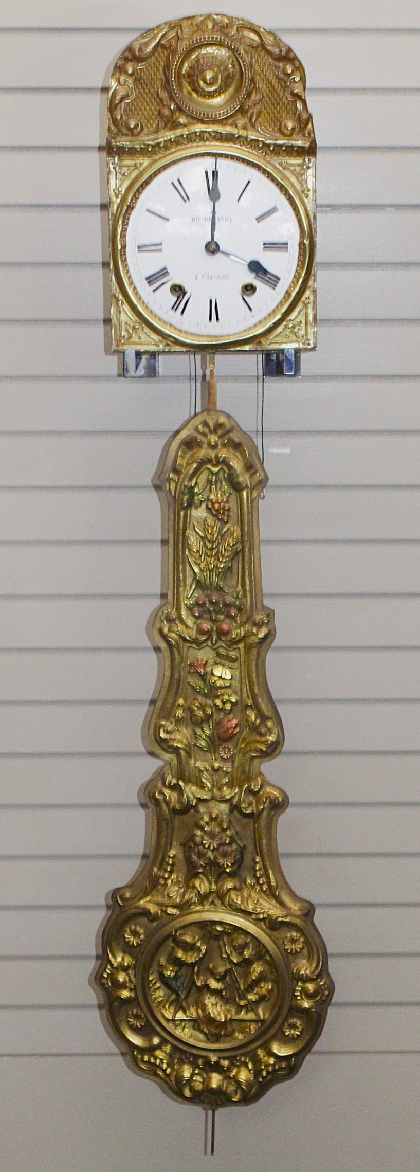 A French Morbier "Wag on the Wall" Clock: Mid 19th century embossed brass with enameled dial mfg. Henri Delafoy in Charmont, VG+ working cond, 59"L.