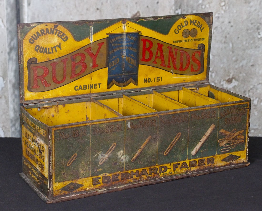A Country Store Rubber Band Counter Display: Tin litho for Ruby Bands mfg by Eberhard-Faber with 5 divisions, G+ cond with some oxidation and wear, 15.5"L.