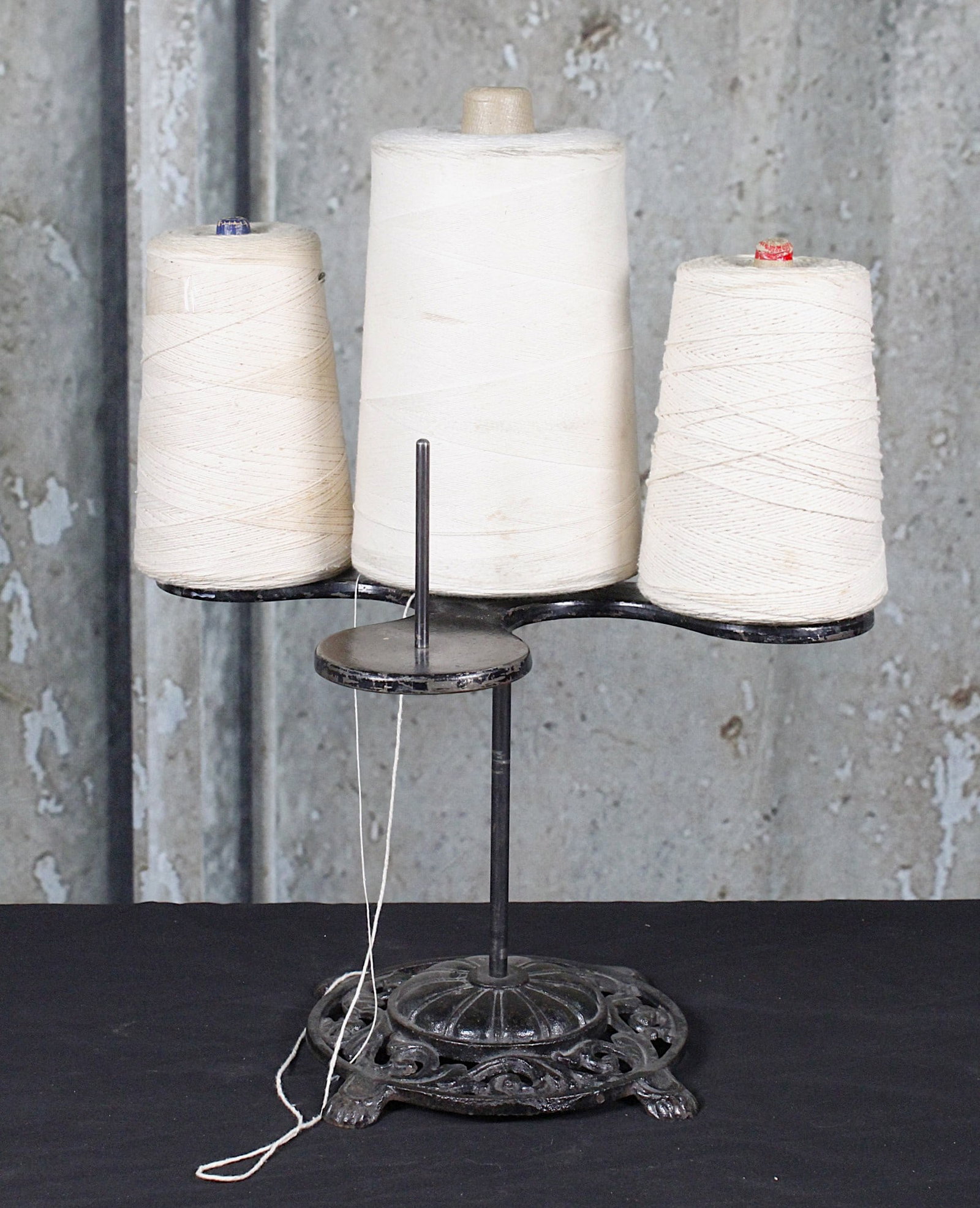 A Country Store String Holder: Cast iron base with spindles for 4 spools and includes 3. VG+ cond 19"H as illustrated.