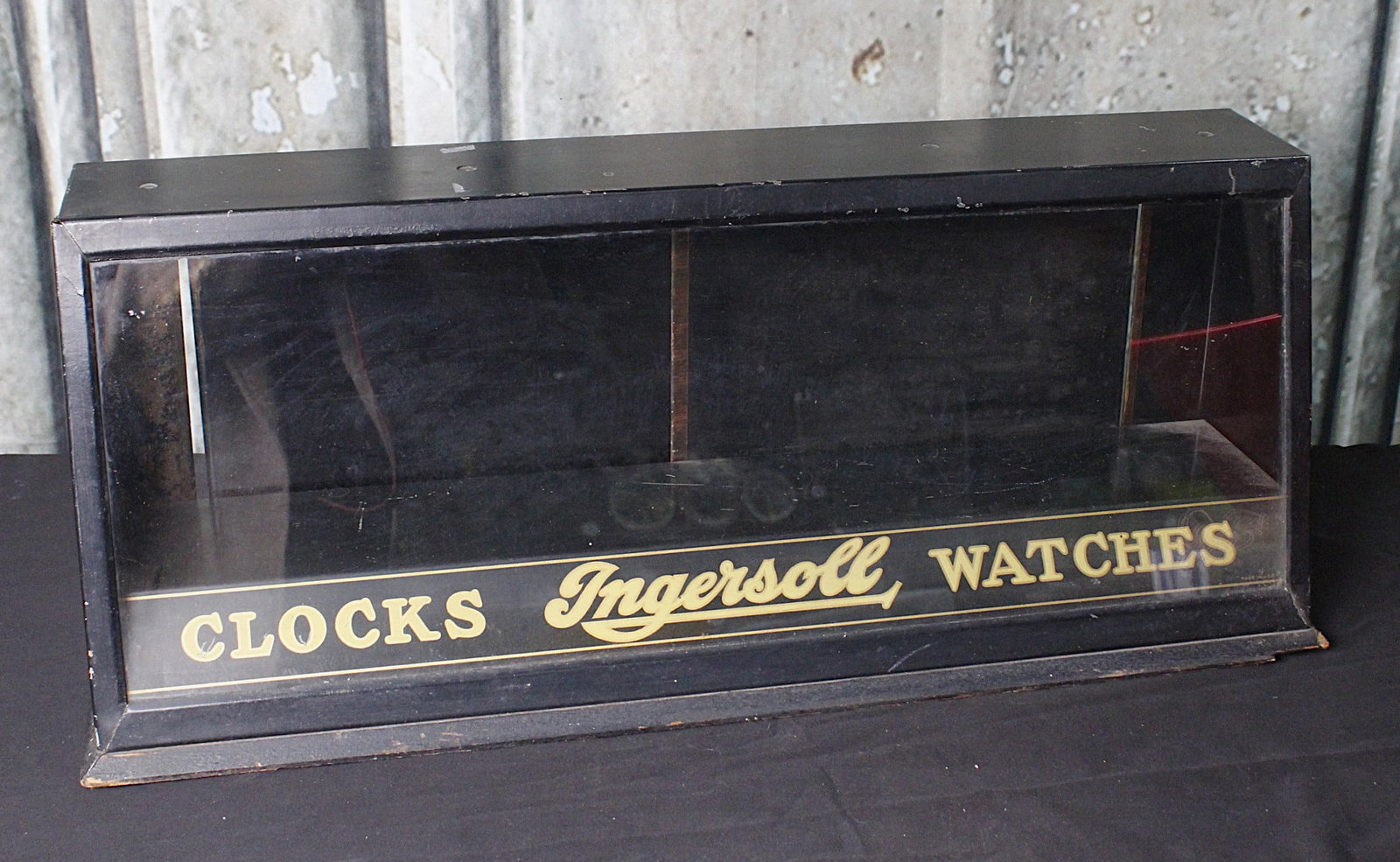 A Jewelry Store Counter Top Display For Ingersoll: Early 20th century with litho on tin marquee in a glazed tin case. VG cond, 10.5"H x 26"W.