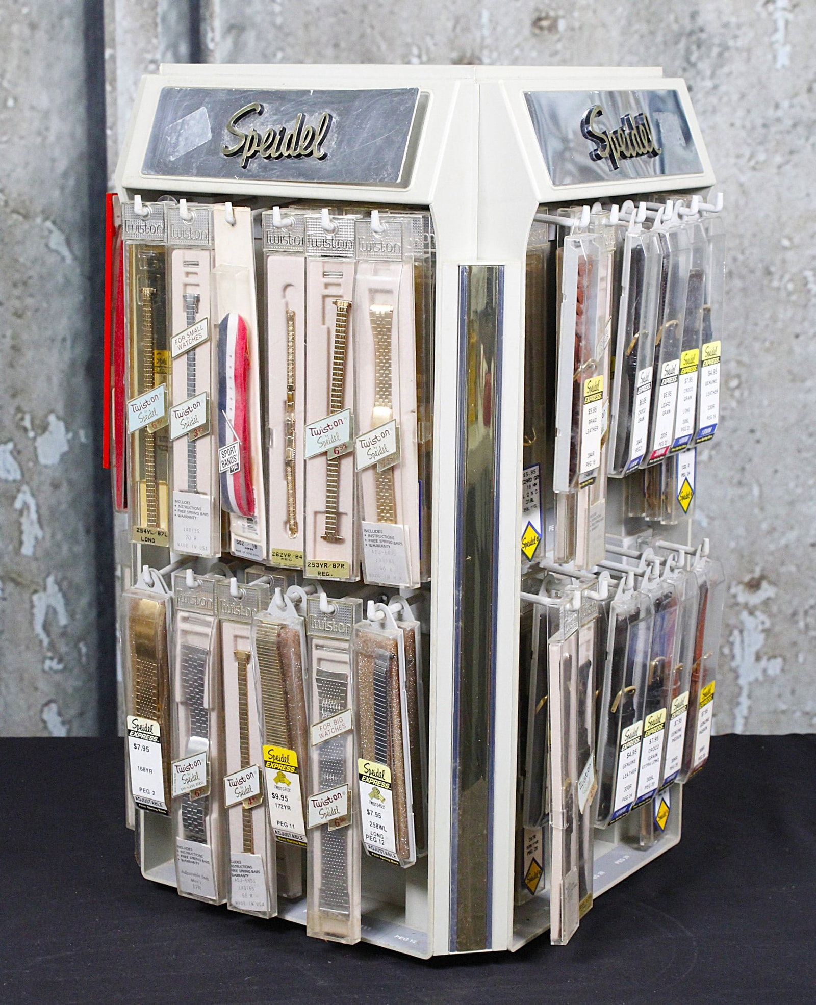 A Speidel Counter Top Watch Band Carousel: MCM with marquees and approx 100 nos bands of various types, VG+ cond 20"H.