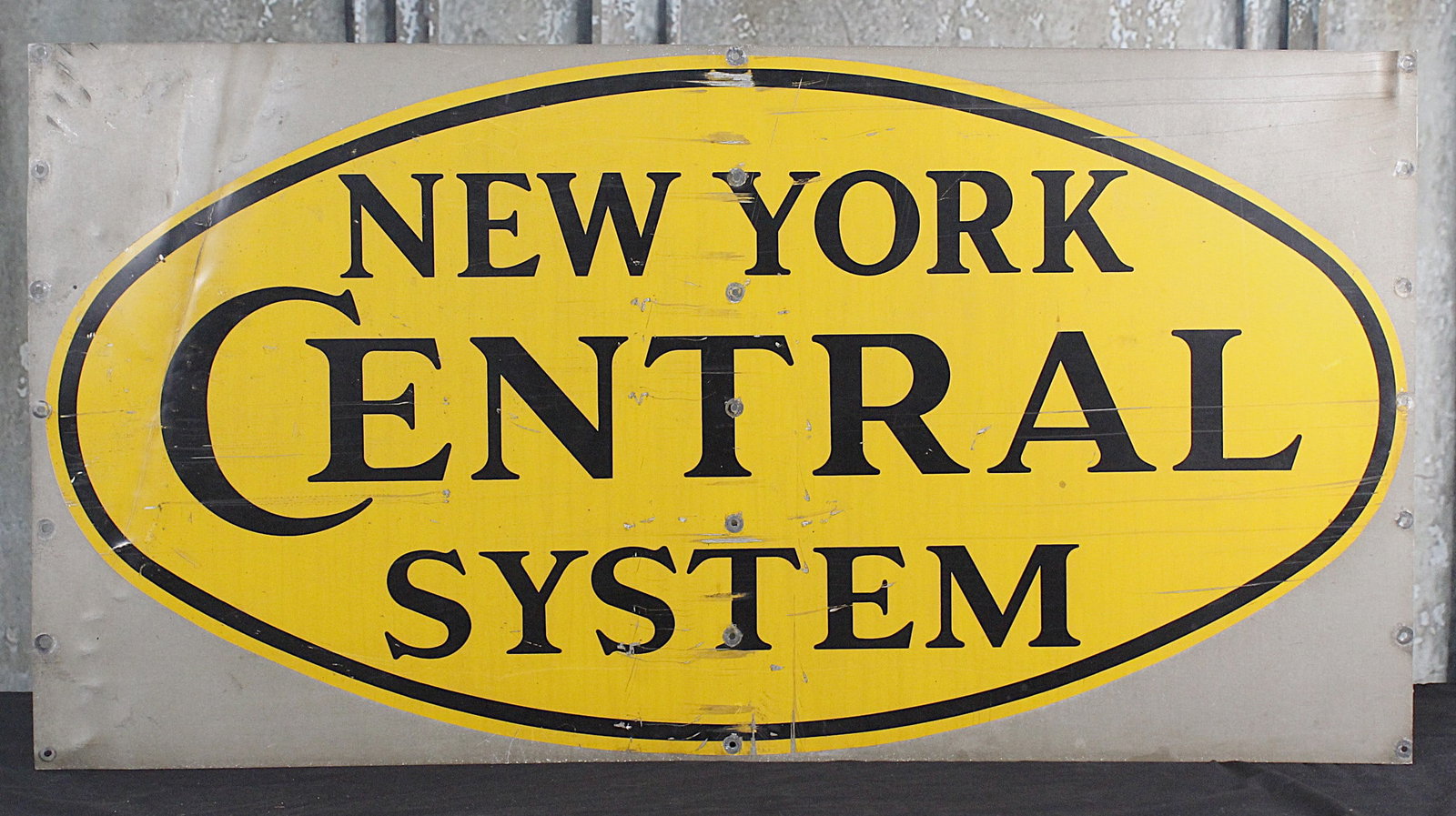 A New York Central System Sign: Painted aluminum G+ cond w/wear. 25"H x 48"W.