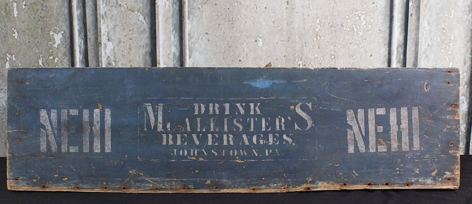 An Early Nehi Wood Advertising Sign: Drink McAllister's Beverages, Jonestown, PA, painted wood early 20th century, G+ cond. 11.5"H x 41"W.