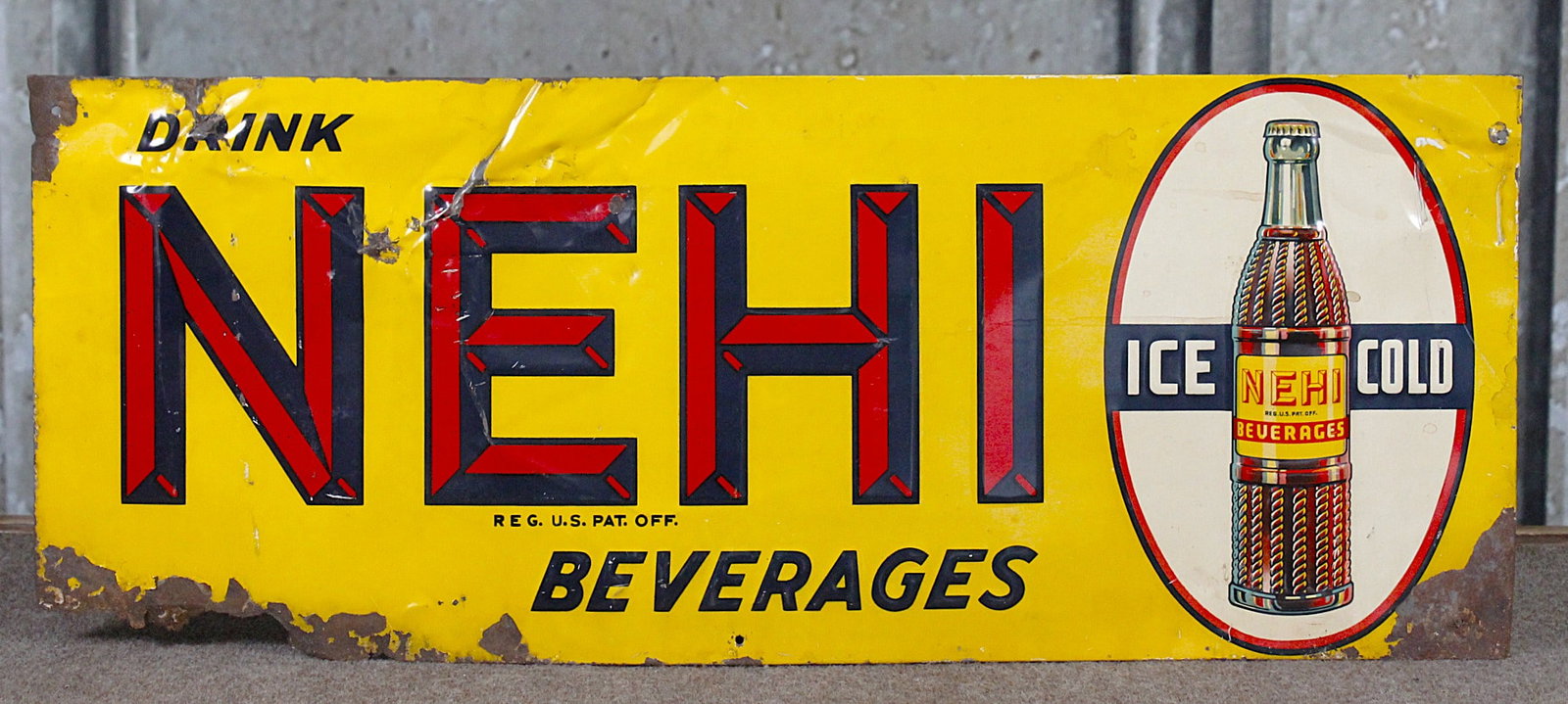 A Drink Nehi Beverages Advertising Sign: Embossed tin, Fair + cond with dings and oxidized erosion, 27"L x 10.5"H