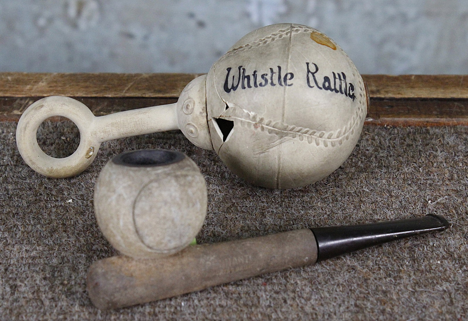 2 Vintage Baseball Novelties: A Rubber ball shape "Whistle Rattle" and a bat/ball form tobacco pipe stamped "Pennant Briar" G+ cond the former w/losses. Largest 5.5"L