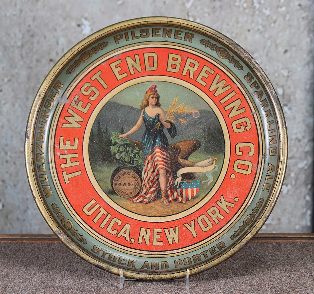 A West End Brewing Co. Pre-Prohibition Serving Tray: Litho on pressed steel with Lady Liberty, G+ cond with some scattered wear. 13"Dia.