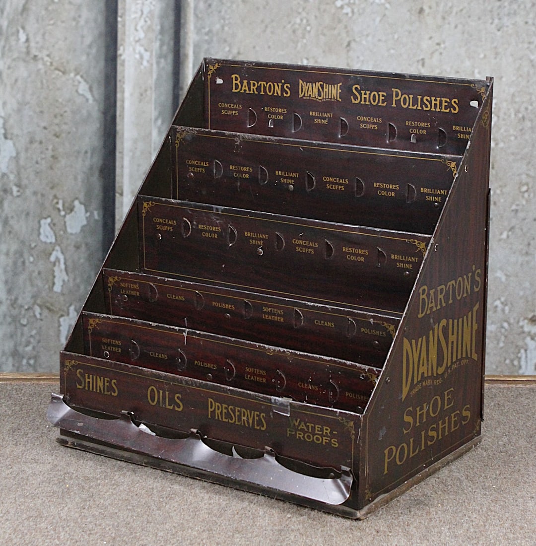 A Country Store Barton's Shoe Polish Display: Litho on tin counter top case for DyanShine w/5 tiers, VG cond with some wear and dings and bends, 14.5"H x 13.5"W x 10"D.