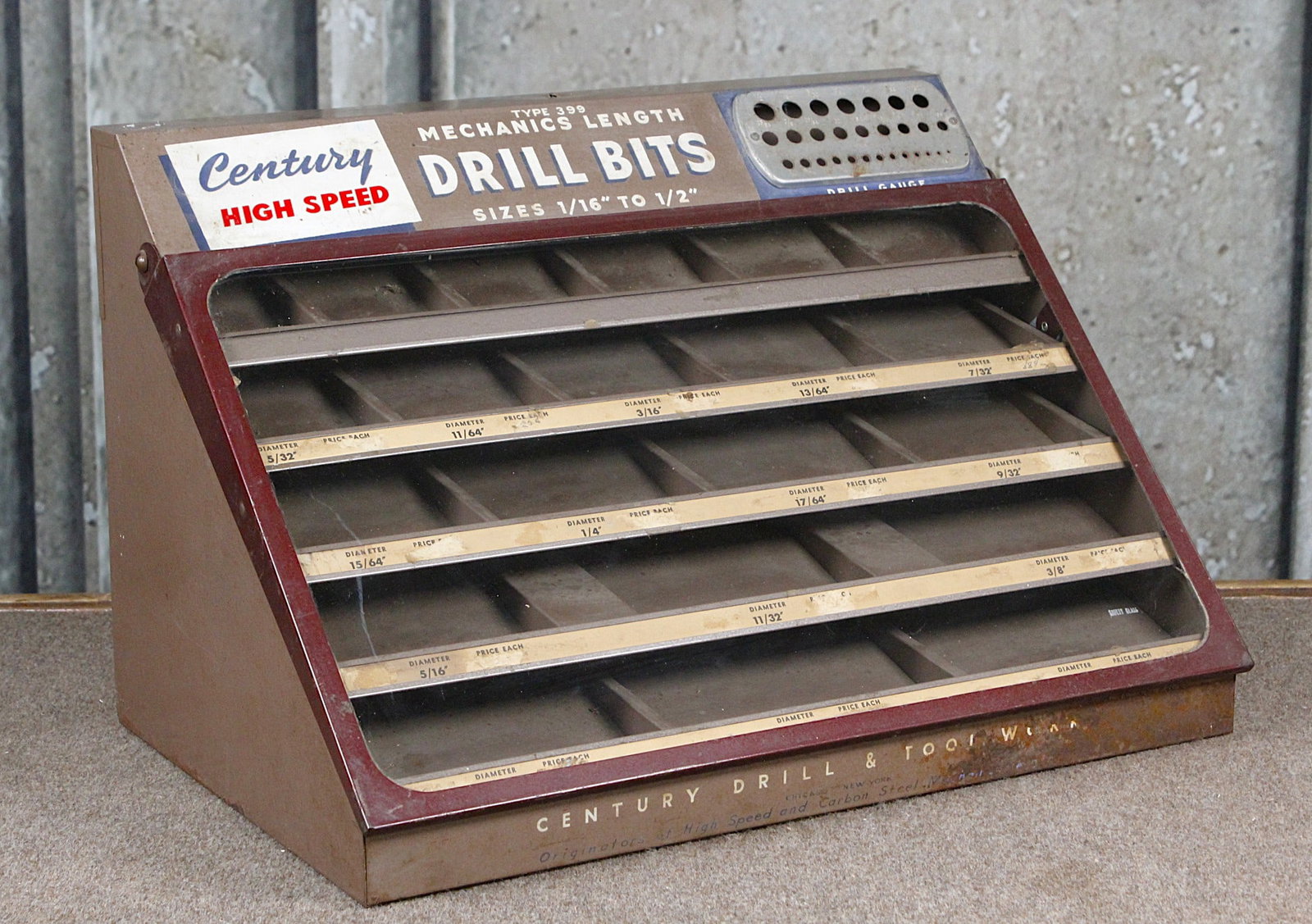 A Century Drill Bit Counter Top Display: Mid 20th c, glazed slant front for bits 1/16th to 1/2", G+ cond with some oxidation, 13"H x 20"W x 13"D.