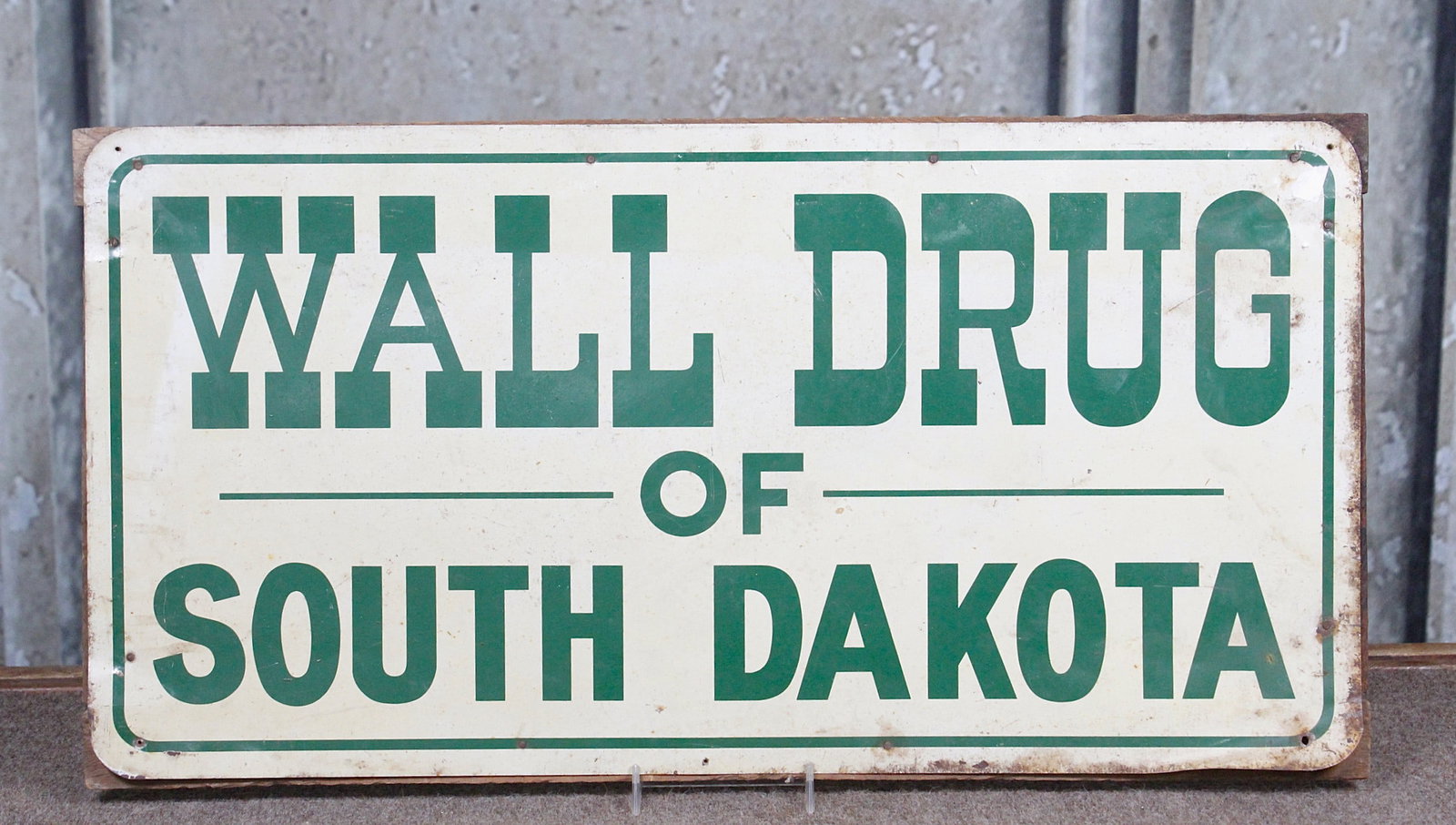 A Wall Drug Sign: Tin Litho mid 20th century, G+ cond w/some bends & edge oxidation, 12"H x 24"W.