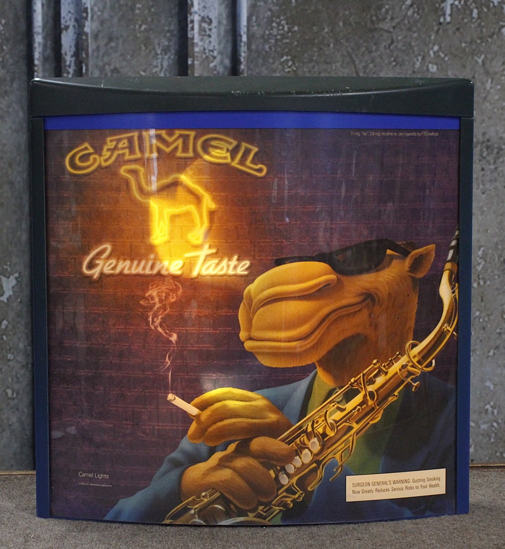 A Joe Camel Lighted Cigarettes Sign: Wall mount 1995 R.J. Reynolds with transparent Graphic VG cond with some color fade, 21"H x 20"W.