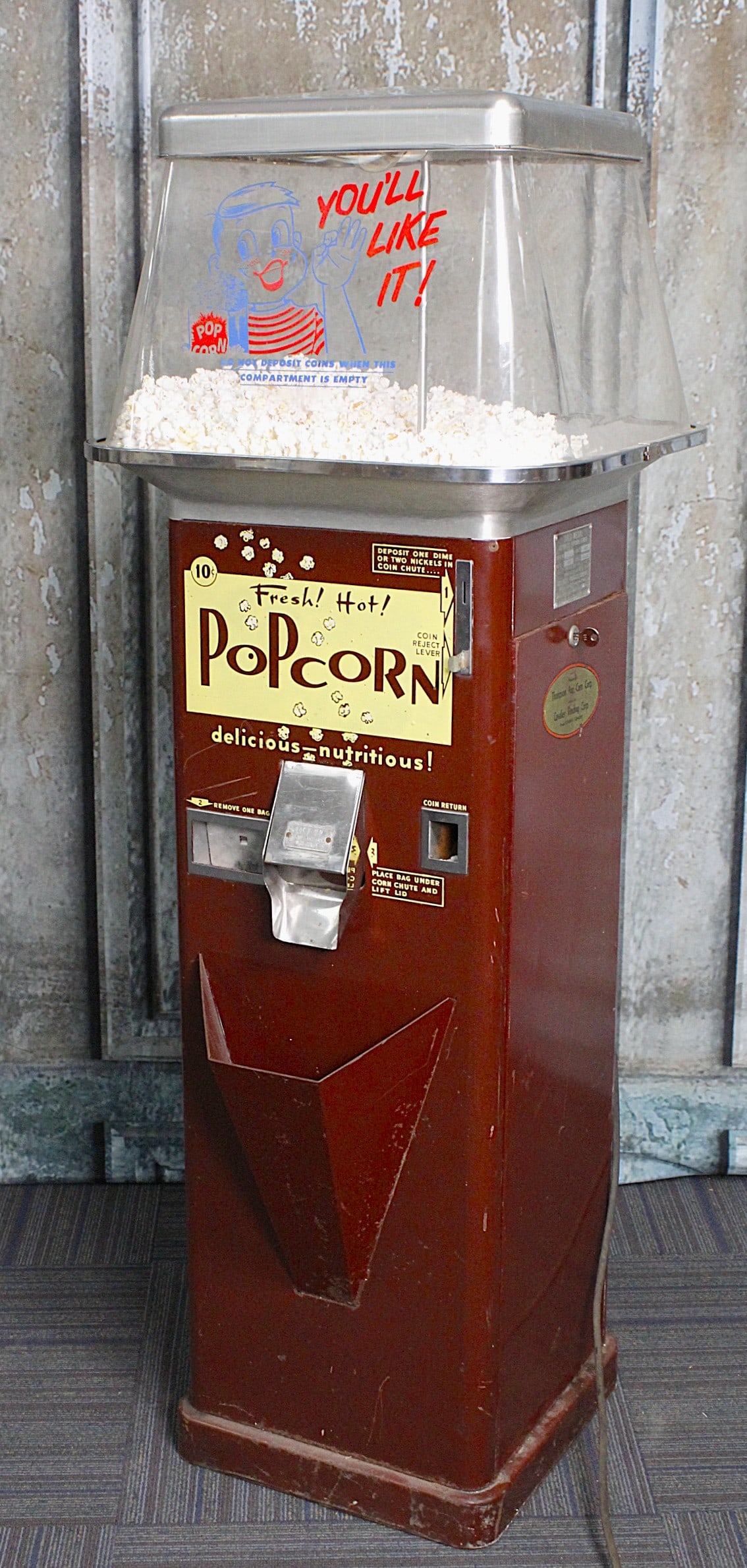 A Gold Medal Automatic Popcorn Vendor: Pressed steel & acrylic c.1950s, ser# 3947, Popper untested, dispenses but portion control not working, otherwise appearance is VG & w/key, 60"H x 21"Sq.