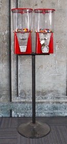 A Two Head Coin Op Gumball Vendor On Stand