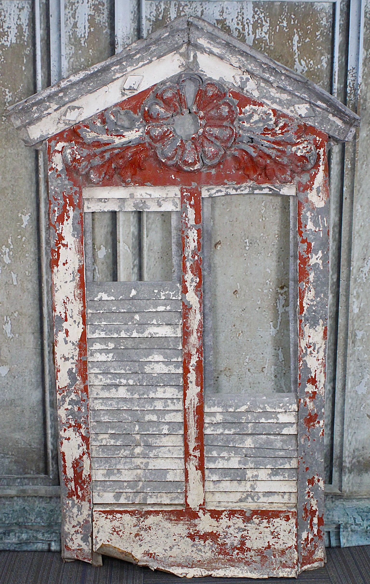 A Victorian Architectural Louver Vent: Pressed galvanized tin with large floral rosette and leaves, F+ cond with damage & losses, 71"H x 44"W.