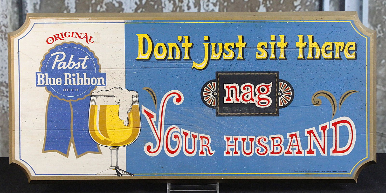 A Pabst Blue Ribbon Tavern Sign: Silk screened shaped wood panel in VG+ cond, 11"H x 24"W.