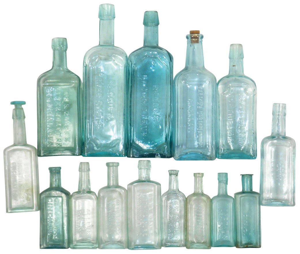 Medicine bottles (15), embossed aqua cork-top glass bot: Medicine bottles (15), embossed aqua cork-top glass bottles from Cinc companies Scovill, Geo. Dixon (1 w/partial German paper label), Dr. Anderson (chipped lip), Kalmus Chemical, Rogers & others, Burd