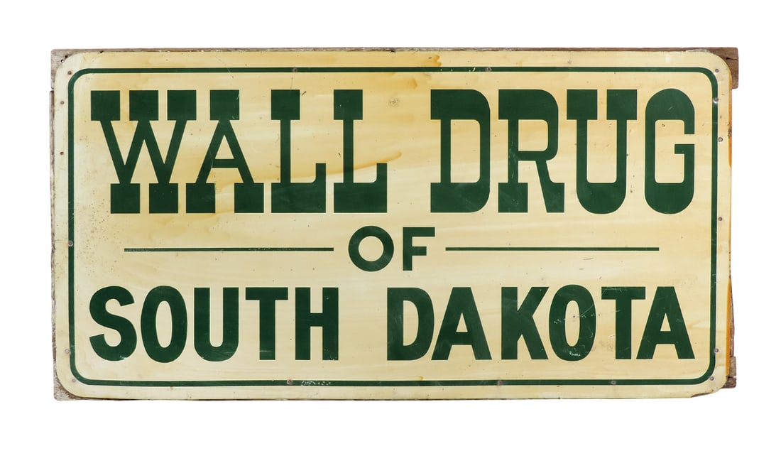 Drug Store Sign, Wall Drug of South Dakota, litho on tin, mounted w/nails on 1 1/2 inch wooden fr...: Drug Store Sign, Wall Drug of South Dakota, litho on tin, mounted w/nails on 1 1/2 inch wooden frame for support, mid 1900s, VG cond w/discoloration/wear to edges, 12"H x 24"W.