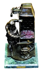 Bronze sculpture sculpture on a marble base of a blacksmith swinging a hammer at a piece of metal on