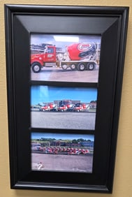 Framed art piece of three concrete mixer trucks