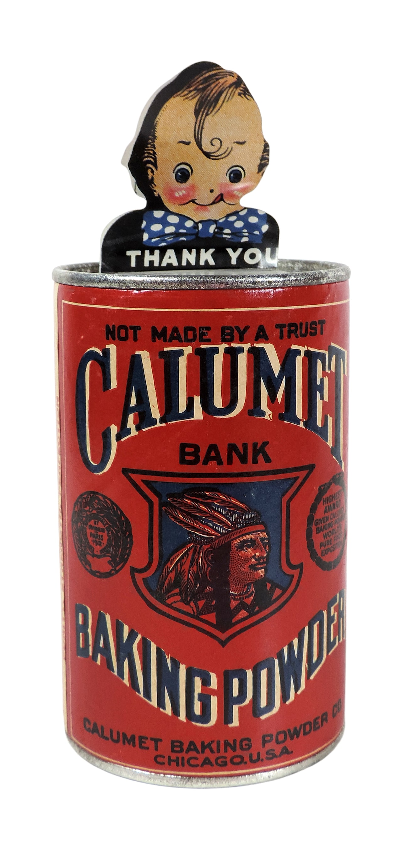 Calumet Baking Powder Bank, die-cut litho on tin Calumet Kid that bobs his head when coin is inse...: Calumet Baking Powder Bank, die-cut litho on tin Calumet Kid that bobs his head when coin is inserted, cardboard label w/tin top & bottom, c. 1920s, o/all Exc cond w/minor corrosion/scuffs, H 5.5 in.
