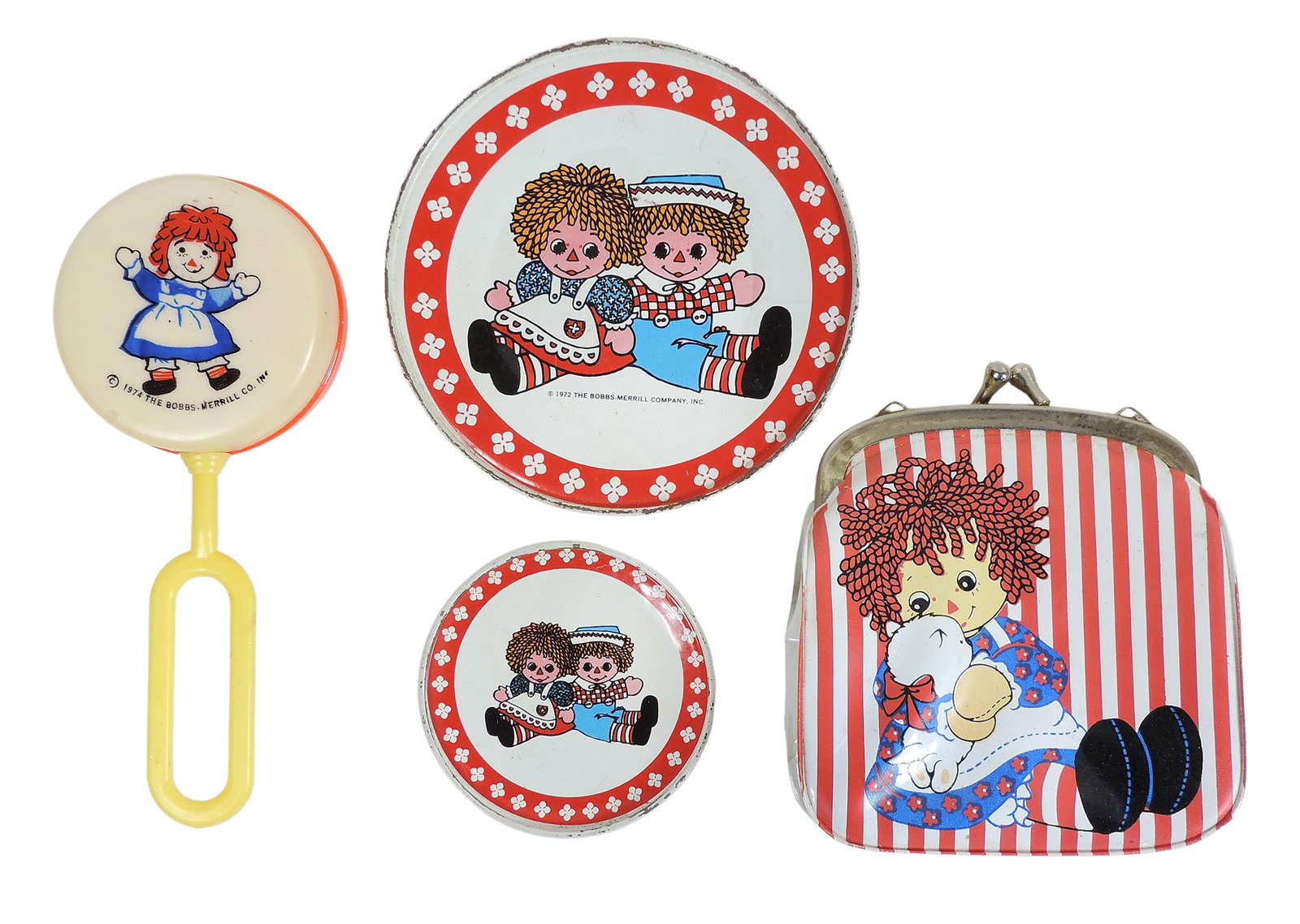 Raggedy Ann and Andy (4), litho on tin children’s play plates (1972), Child’s Baby Rattl: Raggedy Ann and Andy (4), litho on tin children’s play plates (1972), Child’s Baby Rattle (1974) & Coin Purse (1975), Hallmark Cards, Inc., all The Bobbs-Merrill Co., Inc., made in Hong Ko
