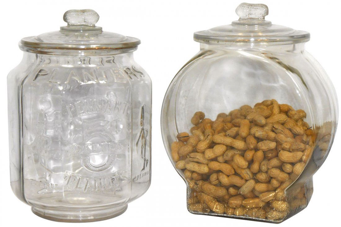 Peanut jars (2), Planters, fully embossed 8-sided jar: Peanut jars (2), Planters, fully embossed 8-sided jar w/peanut lid & football jar w/peanut lid, both Exc cond, 10" & 13"H.