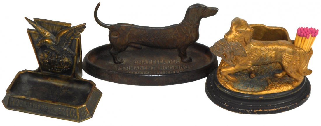 Advertising cigar cutter, match & cigar holders (3),: Advertising cigar cutter, match & cigar holders (3), cast iron dachshund w/cigar cutter in tail from "Paraflint & Paracote-Chatfield's Permanent Roofing", CI keystone w/eagle on globe from "Talon Hook