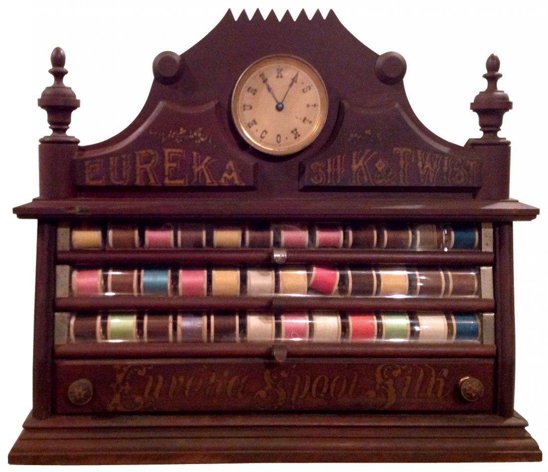 Spool cabinet, Very Rare Eureka, walnut 4-drwr w/orig: Spool cabinet, Very Rare Eureka, walnut 4-drwr w/orig clock gallery, clock has letters spelling Eureka Silk Co. in place of numbers, c.1880's, Exc cond, 22"H x 19"W x 16"D.