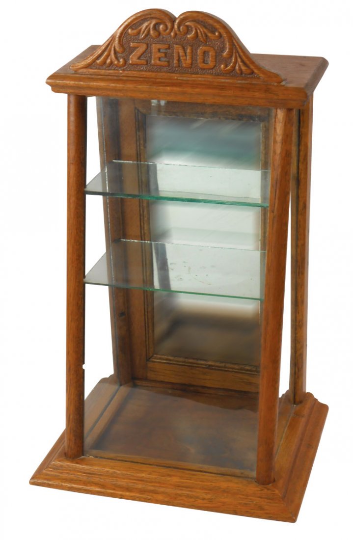 Zeno Gum case, slanted oak case w/adv marquee (older: Zeno Gum case, slanted oak case w/adv marquee (older style), mirrored back door, missing knob & bottom glass shelf, o/wise Exc cond, 18"H x 10.5"W x 8"D.