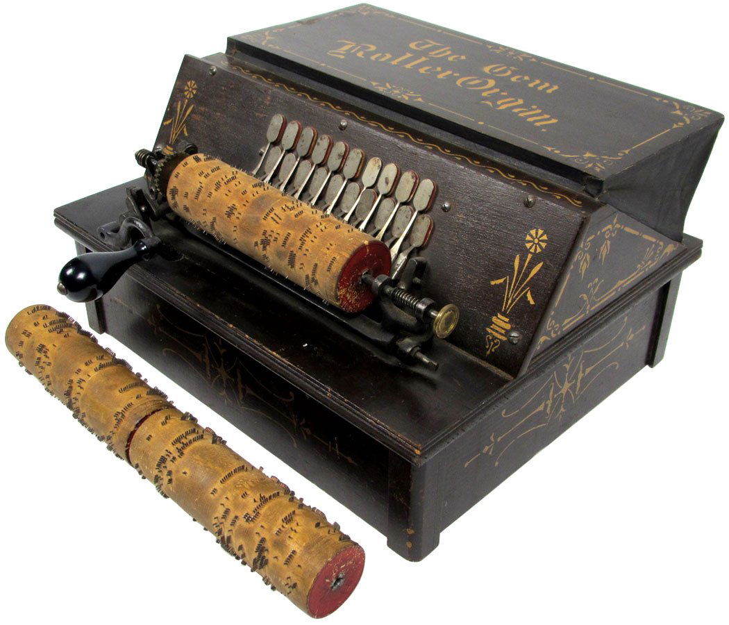 Musical instrument, Gem Roller Organ w/3 cobs, c.1889,: Musical instrument, Gem Roller Organ w/3 cobs, c.1889, wood case w/Exc graphics, works & plays well, rub marks & scuffs on leather covering, o/wise VG+ cond, 8"H x 14.25"W x 12"D.