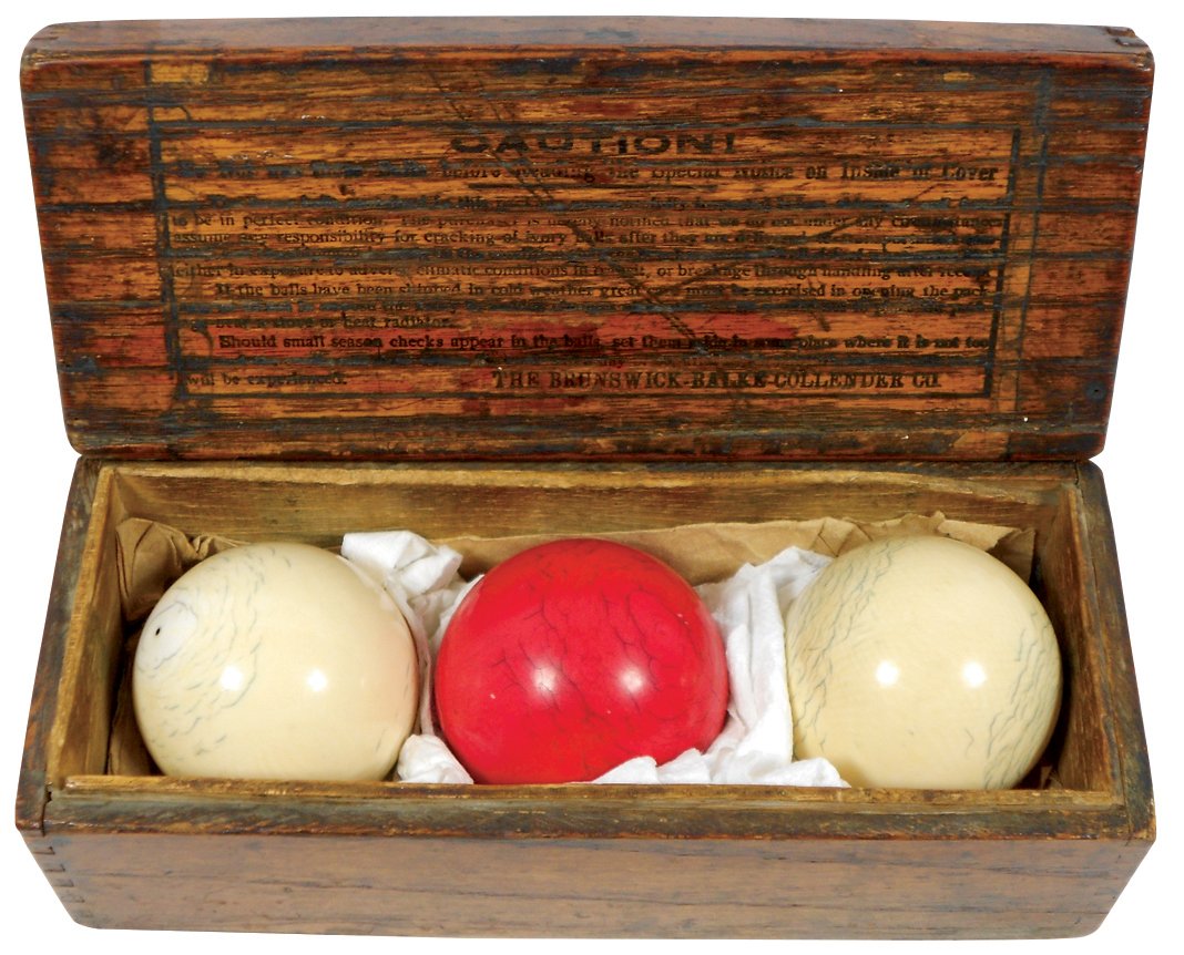Billiard balls (3), 2.25" ivory carom balls in: Billiard balls (3), 2.25" ivory carom balls in Brunswick-Balke-Collender Co. dovetailed wood box w/"Caution" citation, c.1900, balls VG cond w/minor wear, box Good cond, 3.5"H x 8.75"W x 3.5"D.