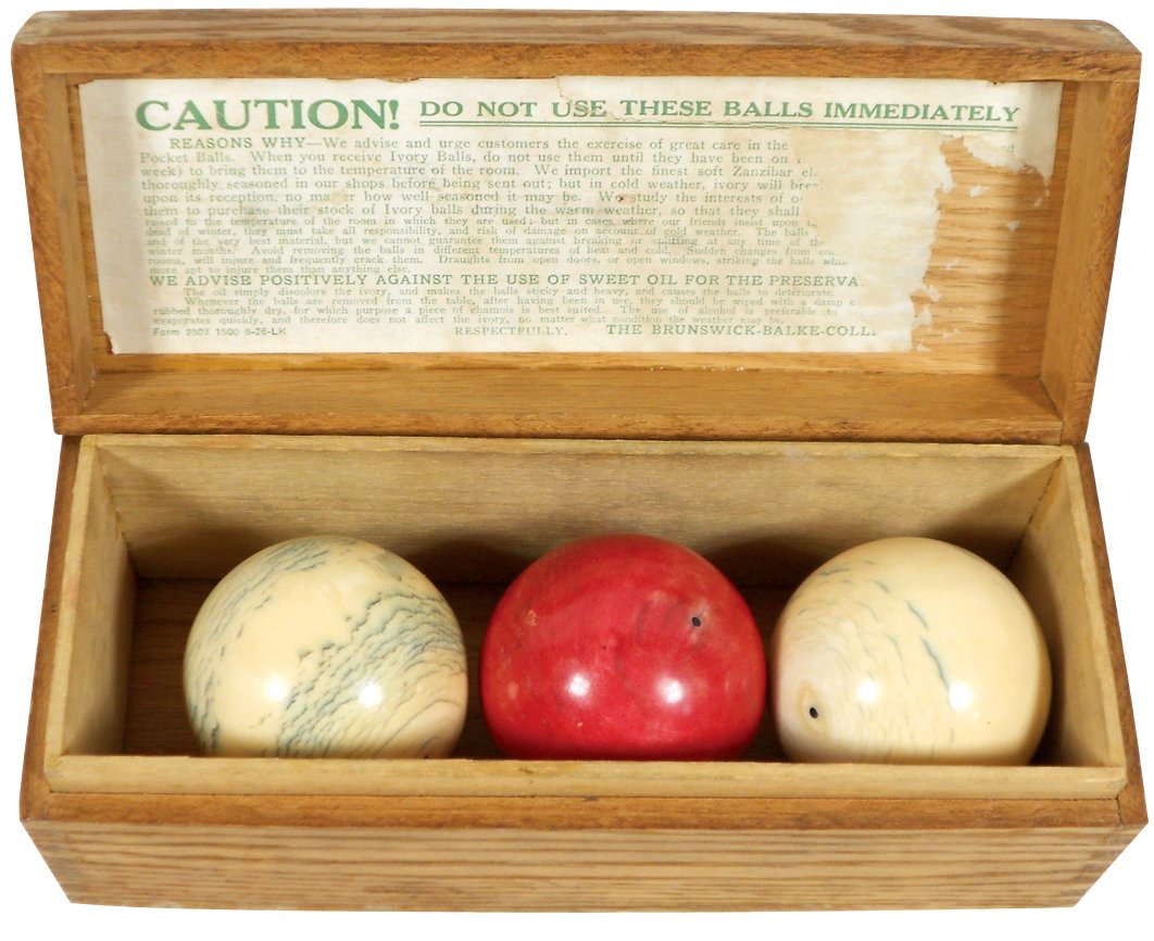 Billiard carom balls & box, dovetailed wood box: Billiard carom balls & box, dovetailed wood box w/"Caution" imprint, 3 ivory 2.25" balls, The Brunswick-Balke-Collender Co., c.1900, Exc cond w/split in bottom of box & small area of wear on one of th