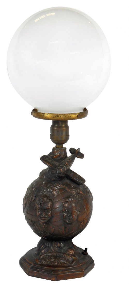 Advertising lamp, Will Rogers & Wiley Post figural lamp: Advertising lamp, Will Rogers & Wiley Post figural lamp w/Wiley, Will & airplane, cast metal w/glass globe, VG cond, 20"H x 8"W.