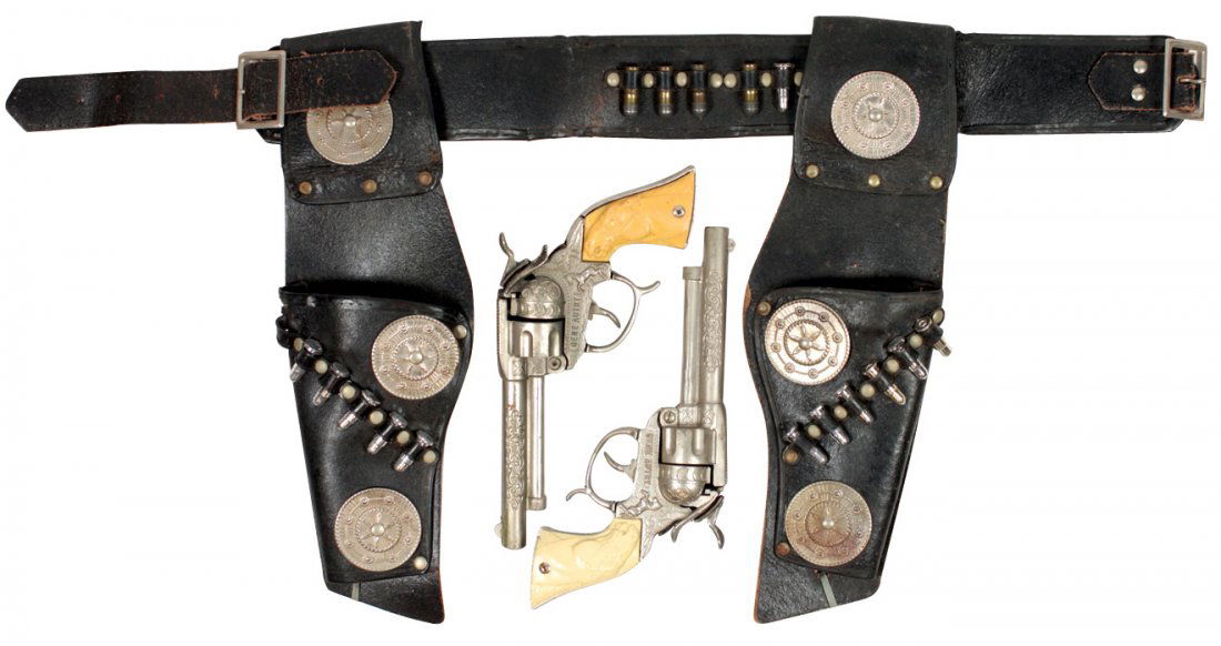 Toy cap guns & holsters, Gene Autry set w/Leslie Henry: Toy cap guns & holsters, Gene Autry set w/Leslie Henry pistols, tip down barrels & caps load from the side, holsters & leather belt have toy bullets, metal embellishments, slight corrosion on metal of