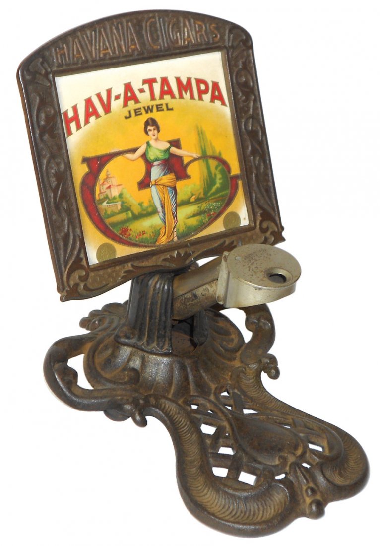 Advertising cigar cutter, HAV-A-TAMPA Havana Cigars,: Advertising cigar cutter, HAV-A-TAMPA Havana Cigars, cast iron w/embossed paper label, mfgd by Brunhoff-Cinc., Exc cond w/orig patina, 7.5"H x 6"W.