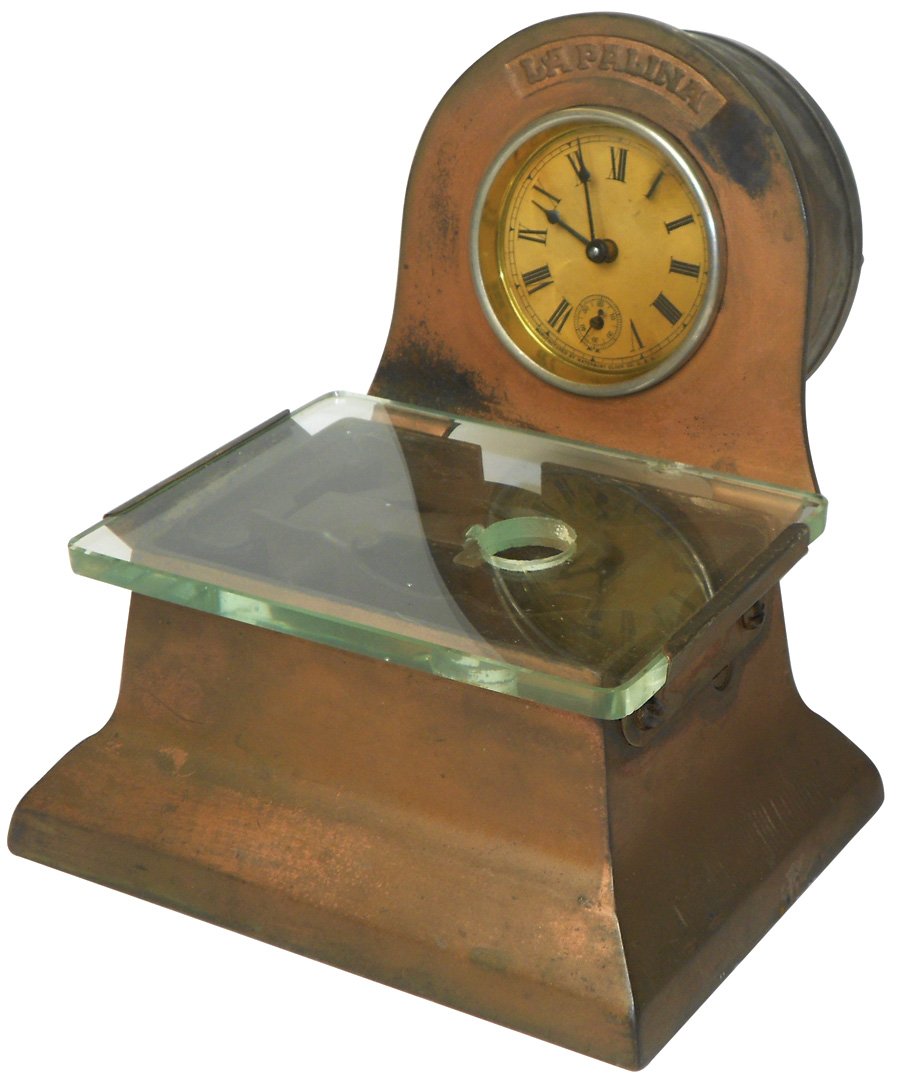 Advertising cigar cutter, La Palina, cast iron w/copper: Advertising cigar cutter, La Palina, cast iron w/copper wash, mfgd by Brunhoff-Cinc., small bruise on back of glass & non-working clock, sm hole on top-possibly for a lighter, VG cond 7"H x 7"W.