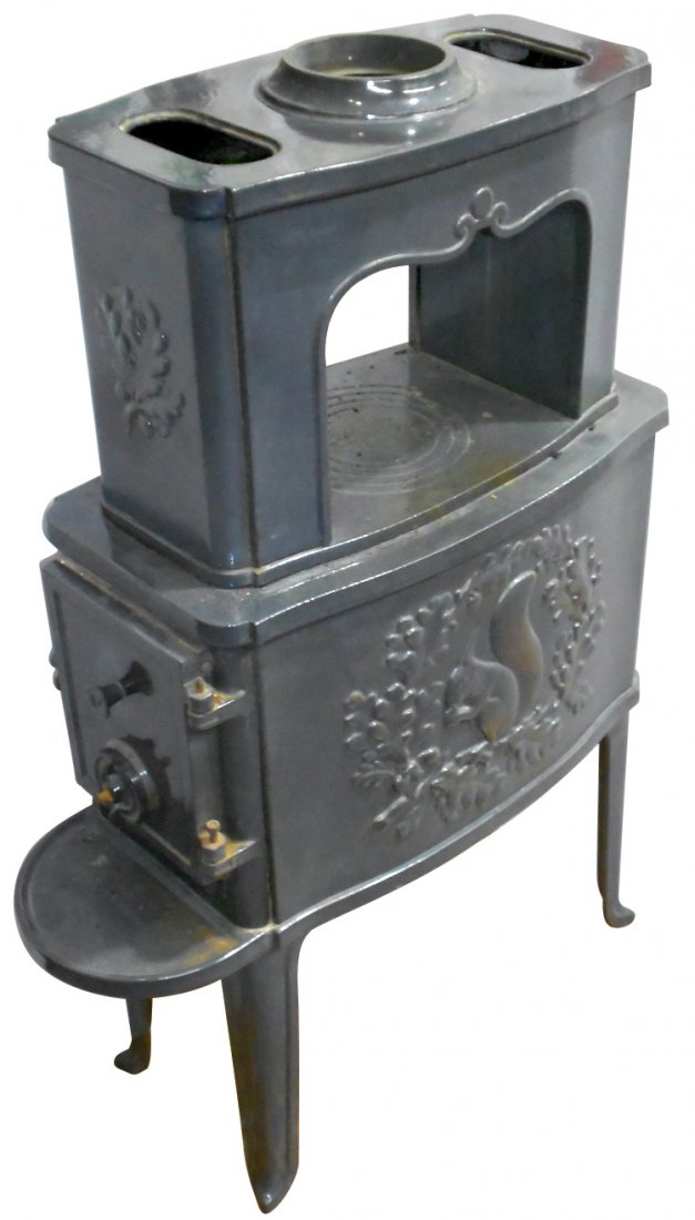 Stove, parlor, cast iron w/gray porcelain surface,: Stove, parlor, cast iron w/gray porcelain surface, embossed "Made in Denmark", squirrel in circle of acorns & leaves on both sides, no top burner plates, o/wise Exc cond, 43"H x 14"W x 28"D.