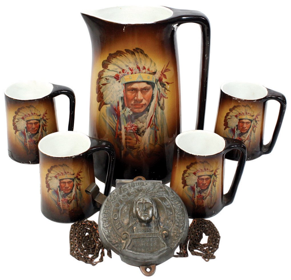 Porcelain tankard & 4 matching mugs w/Indians, marked: Porcelain tankard & 4 matching mugs w/Indians, marked A12 on bottoms, VG cond w/some paint loss 10" & 4"H & Round Oak Stoves Doe-Wah-Jack cast metal flue regulator w/pull chain, Exc cond, 5"Dia.