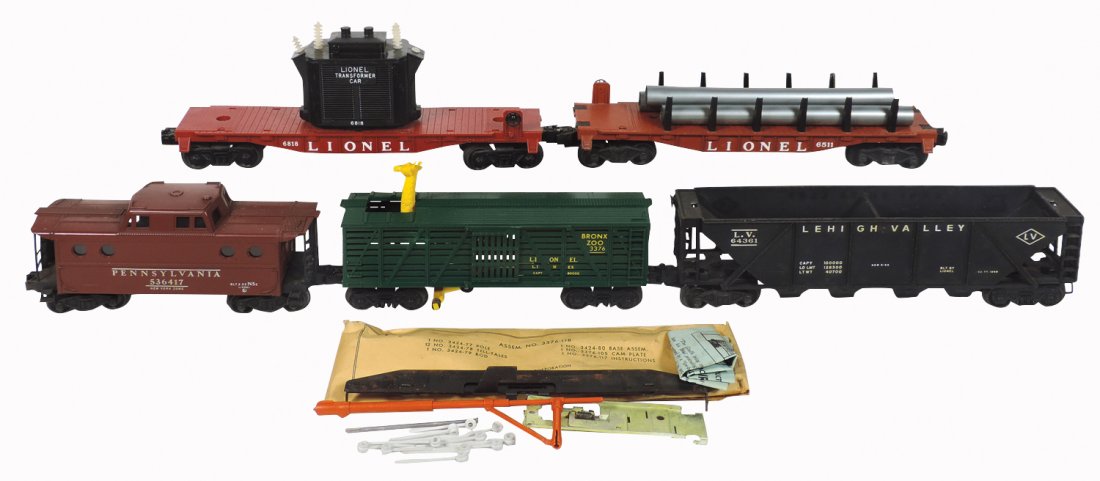 Model train cars (5), Lionel Lines O gauge, 3376: Model train cars (5), Lionel Lines O gauge, 3376 Bronx Zoo w/giraffe, Exc w/instructions, 9.5"L; 6511 flat w/tubes, VG+, 11"L; 536417 Pennsylvania caboose, 2-53, Exc, 8.5"L; 6818 transformer, Exc, 11"
