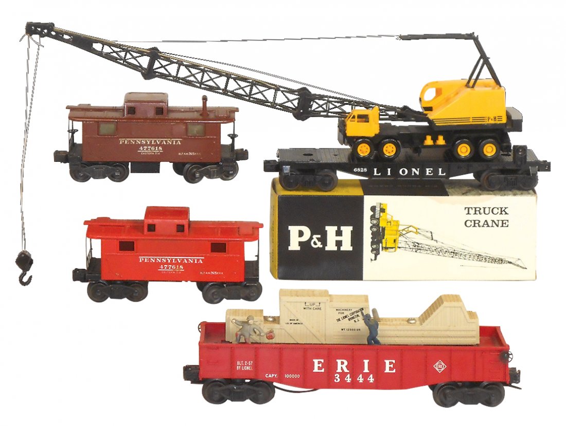 Model train cars (4), Lionel O gauge, 6828-100: Model train cars (4), Lionel O gauge, 6828-100 Harnischfeger truck crane w/box, Exc, 20"L; (2) 477618 caboose, VG, 7.5"L & 3444 Erie animated w/cop & hobo, 2-57, Exc, 10.5"L.