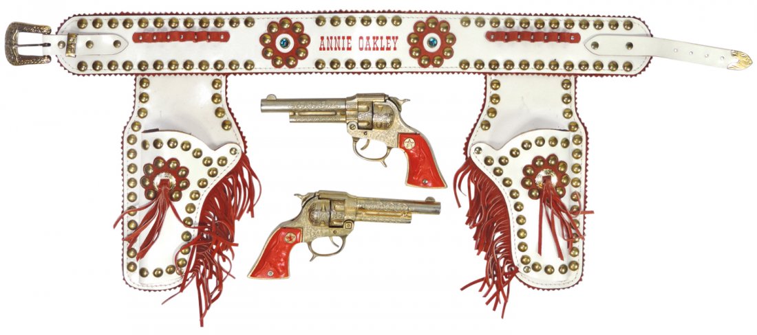 Toy gun, Annie Oakley gun & holster set, Texan Jr. cap: Toy gun, Annie Oakley gun & holster set, Texan Jr. cap guns w/plastic grips w/embossed steer & star, Exc cond, guns 8.75"L.