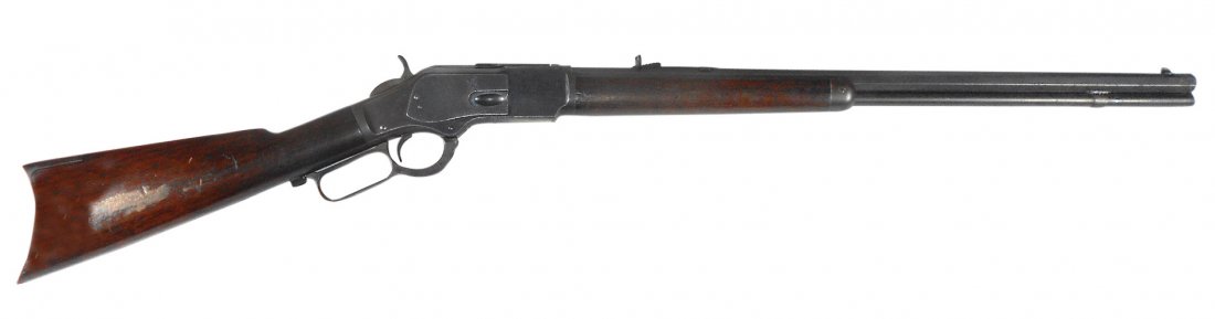 Firearm, rifle, Winchester Model # 1873 lever action,: Firearm, rifle, Winchester Model #1873 lever action, .32 cal carbine, octagon barrel, metal butt plate, walnut stock, VG+ cond, barrel 23.5"L, total length 43"L.