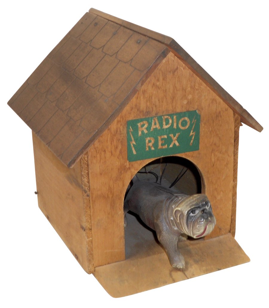 Toy, Radio Rex Teletoy, mfgd by John Hugo Mfg Co.-New: Toy, Radio Rex Teletoy, mfgd by John Hugo Mfg Co.-New Haven, CT, patd 1913, wooden kennel w/celluloid dog, place Rex against flapper, call his name or clap hands to see Rex dash out, a fun toy in Exc 