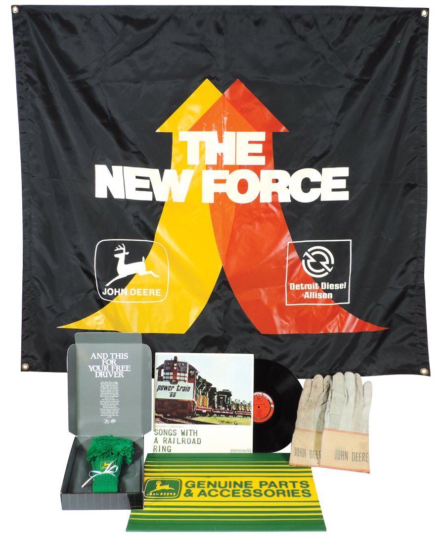John Deere memorabilia (4), "The New Force" banner,: John Deere memorabilia (4), "The New Force" banner, Genuine Parts & Accessories rubber floor mat, Power Train '66 "Songs with a Railroad Ring," leather & canvas work gloves & 150th Anniversary knitted